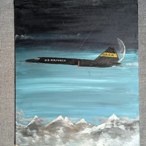 Detail: Aircraft over mountains.