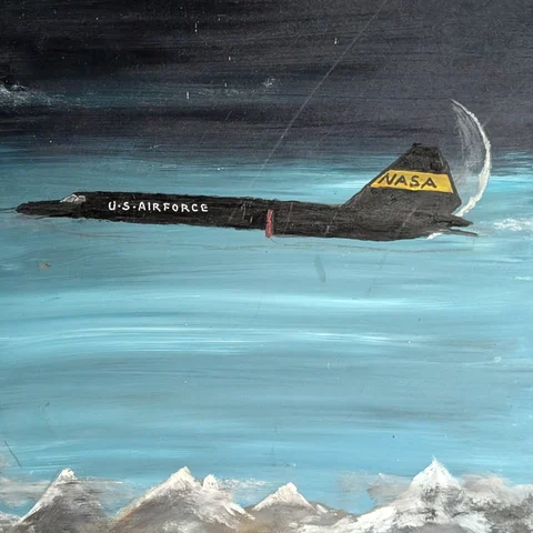 Detail: Aircraft over mountains.