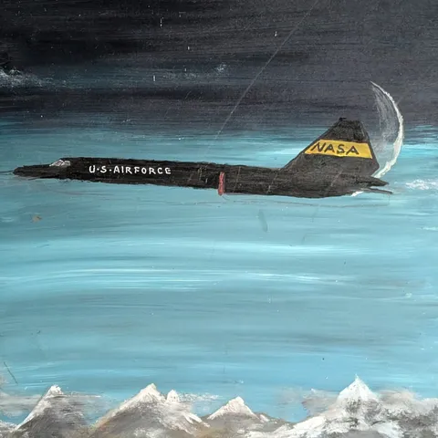 Detail: Aircraft over mountains.
