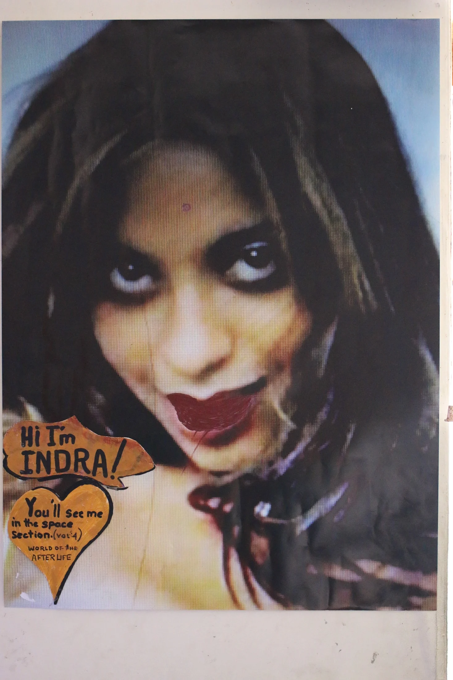 A portrait image labelled Indra on a studio wall.